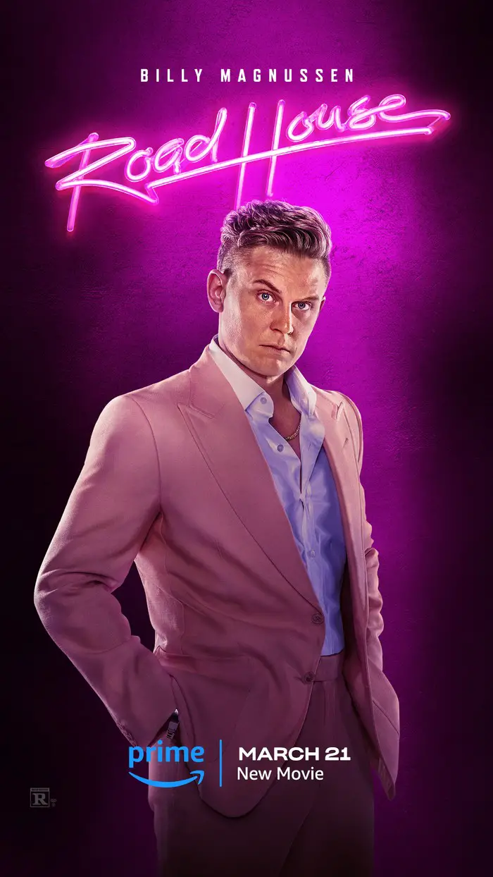 Billy Magnussen poses in a pink suit as Ben Brandt for Road House.