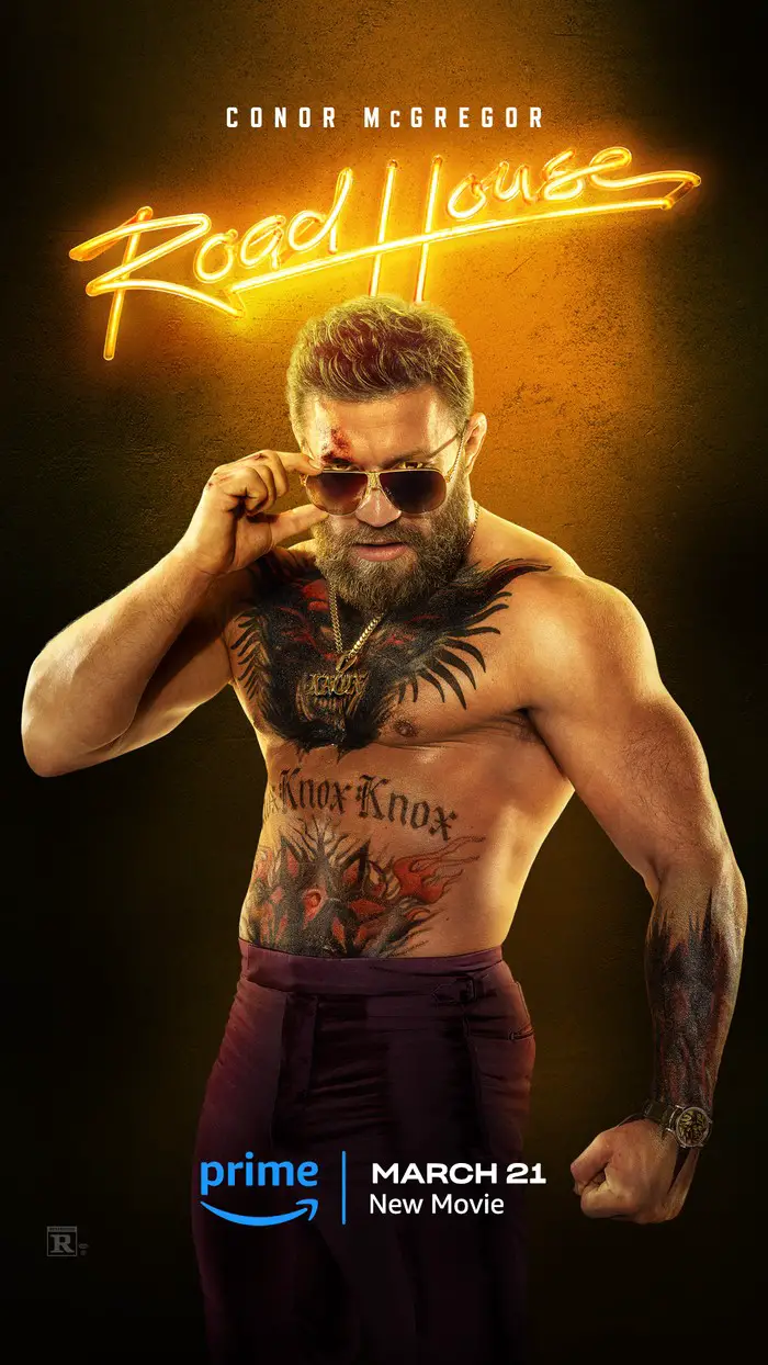 Conor McGregor poses topless, hands on his sunglasses, as Knox for Road House.