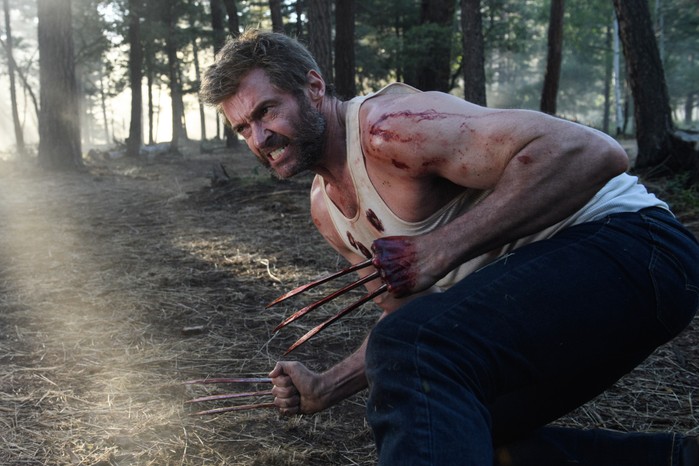 Hugh Jackman as Wolverine in Logan wearing a white vest, claws out