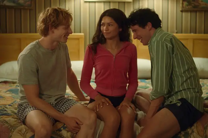 Mike Faist as Art, Zendaya as Tashi and Josh O'Connor as Patrick in Challengers were sitting together on a bed