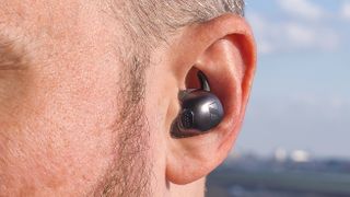 Sennheiser Momentum Sport earphone close-up in the ear.