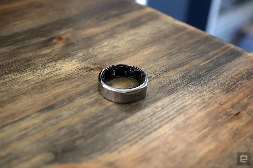 The third generation Oura Ring placed on a wooden table.