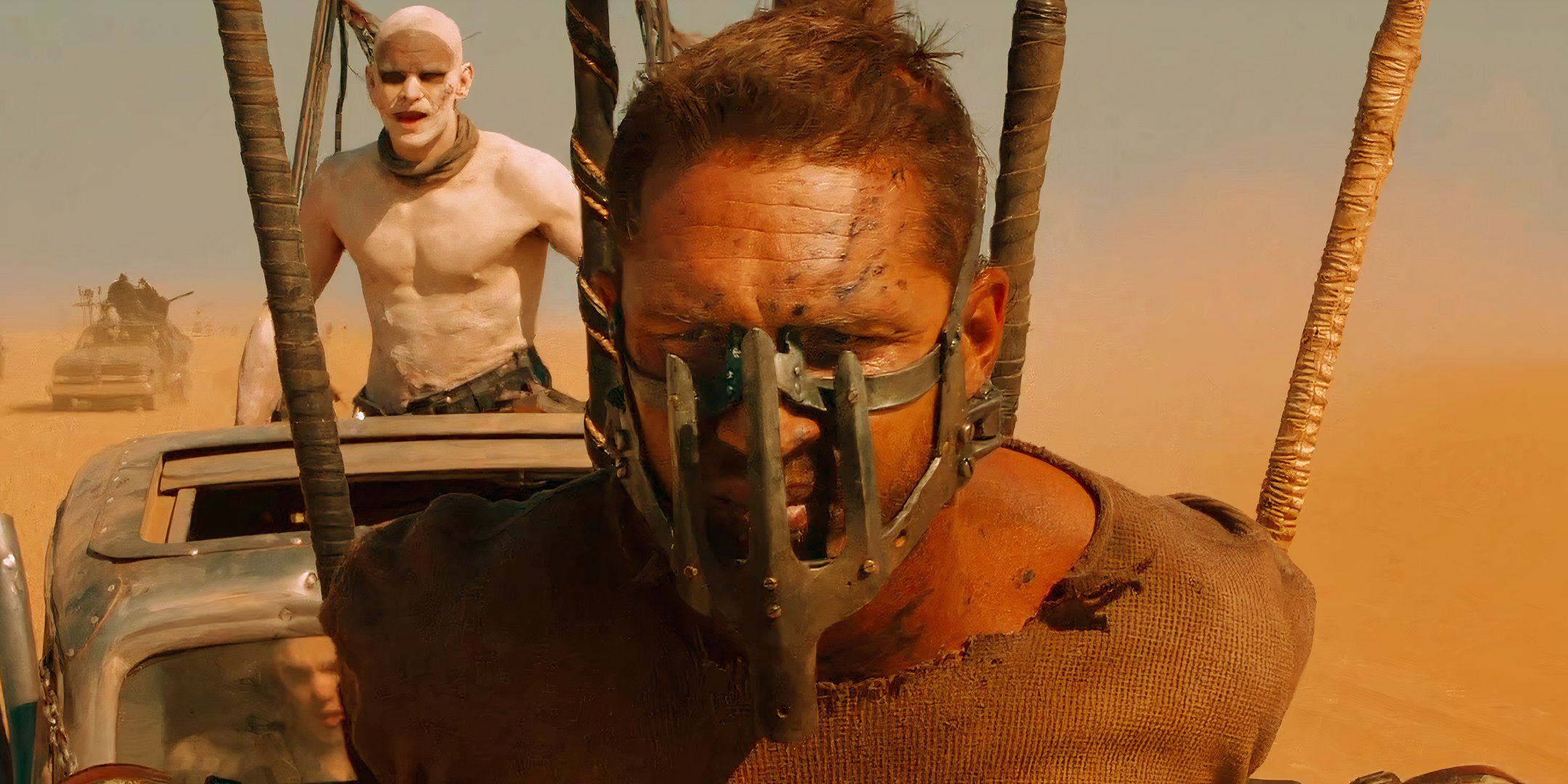 Tom Hardy as Max wearing a mask and chained to a car in Mad Max Fury Road
